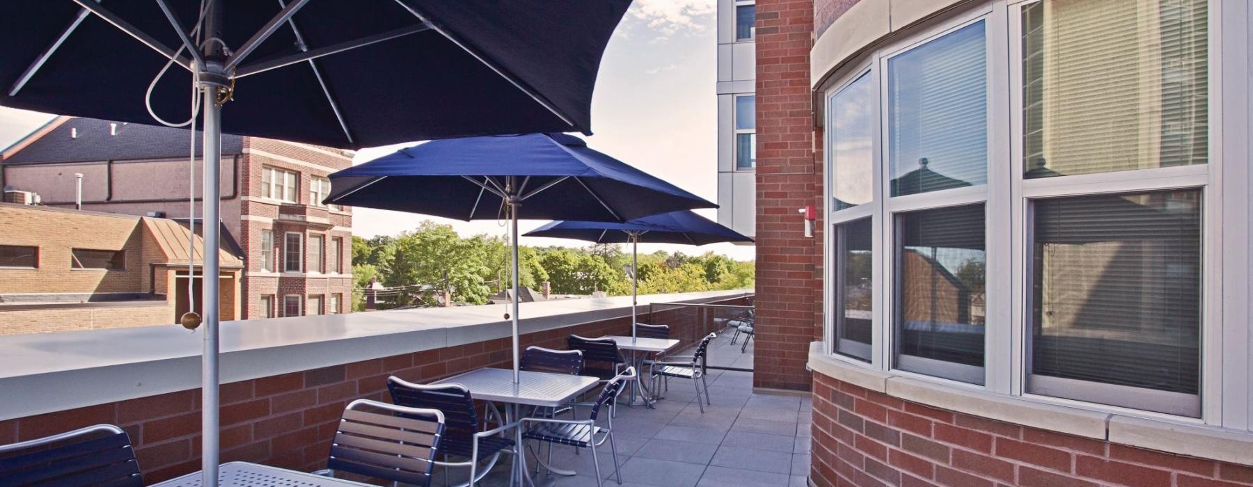 a patio with tables and chairs