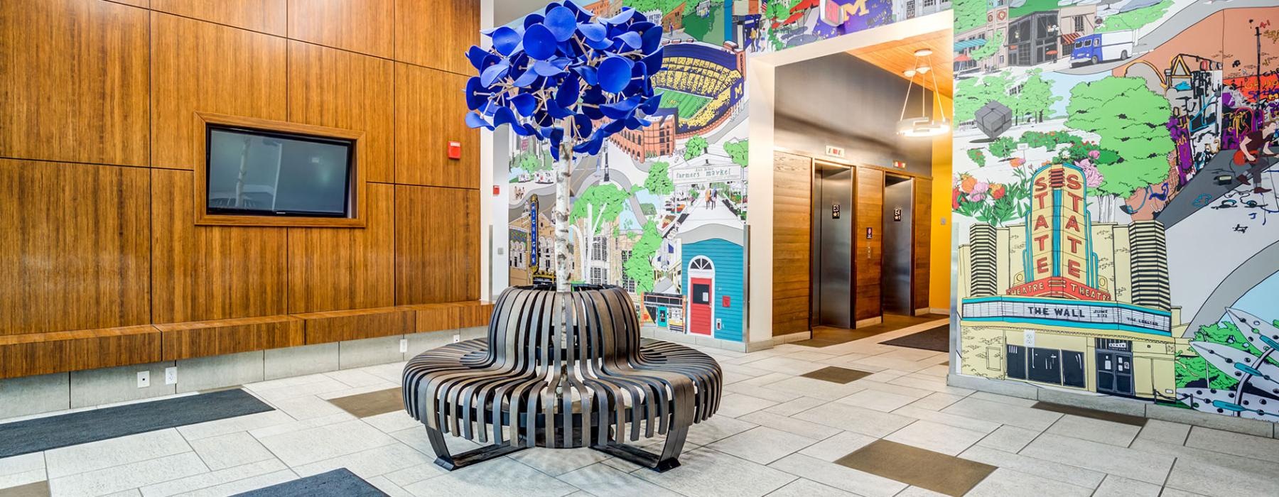 a room with a wall of art